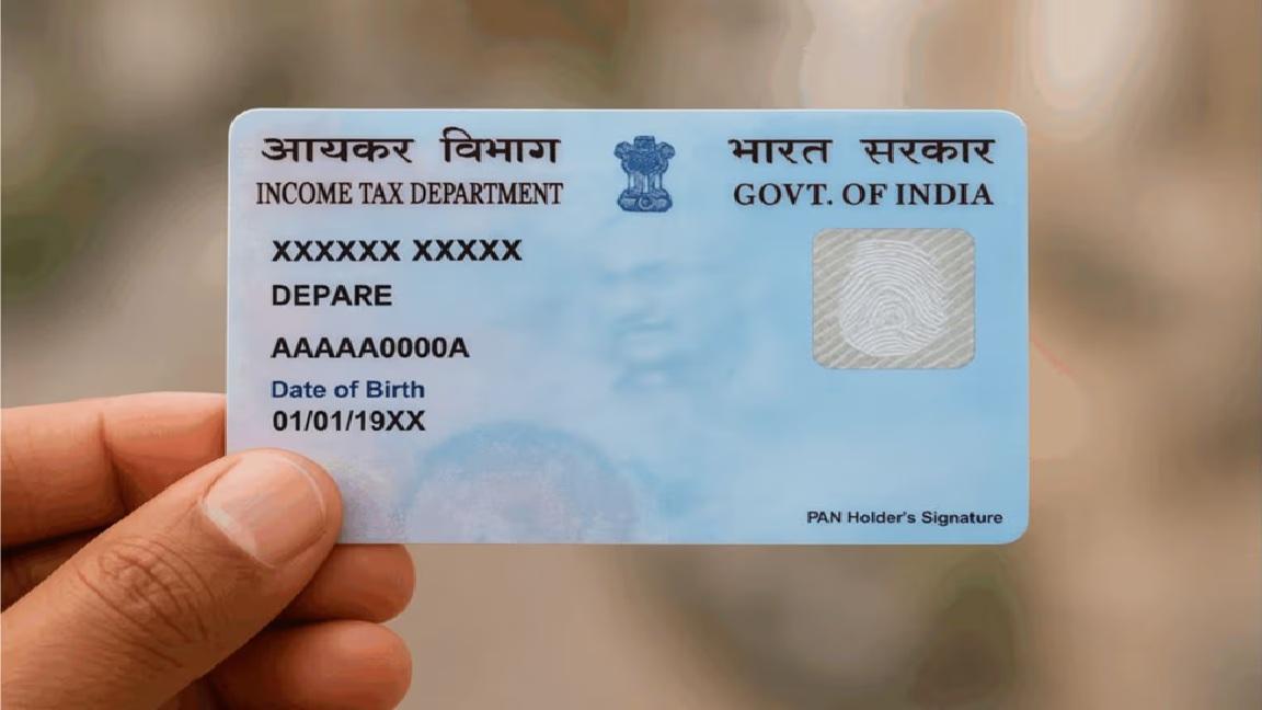 Indian PAN card on a desk with Aadhaar and a smartphone — online application